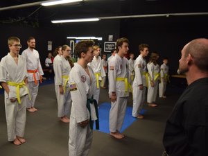 Tae kwon do students in white uniforms lined up to start class